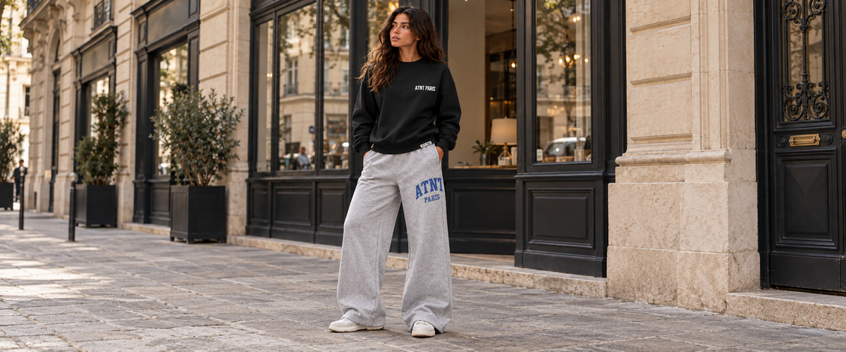 Sweat Col rond Noir –  Essentials porté dans une ambiance lifestyle ATNT PARIS